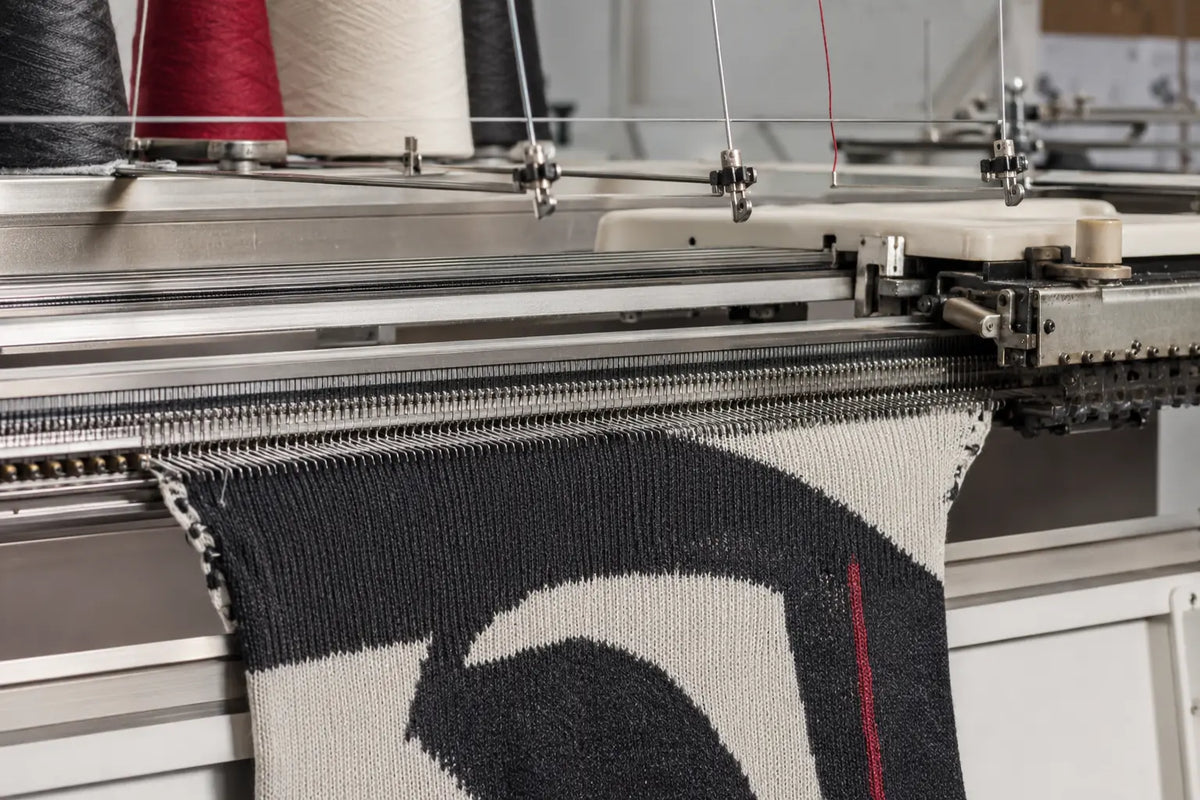 Knitwear being constructed on a knitting machine