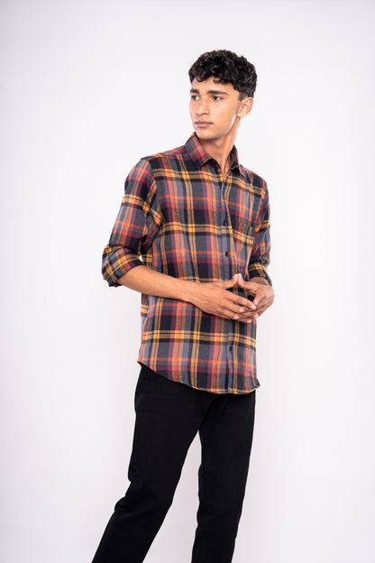 Man wearing a plaid shirt and black pants on a white background