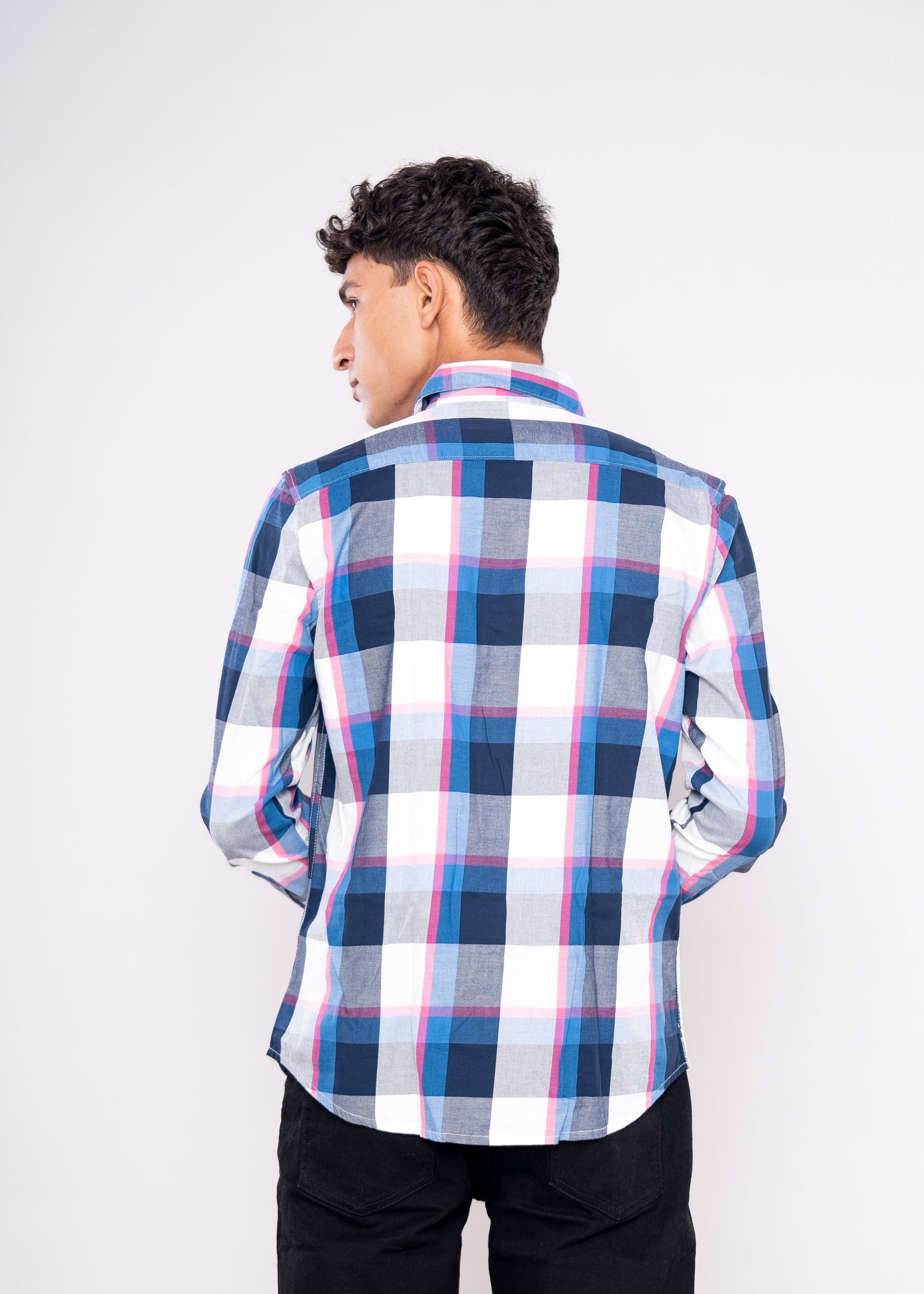 Person wearing a blue and white checkered shirt on a white background