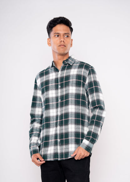 Man wearing a green and white plaid shirt against a white background