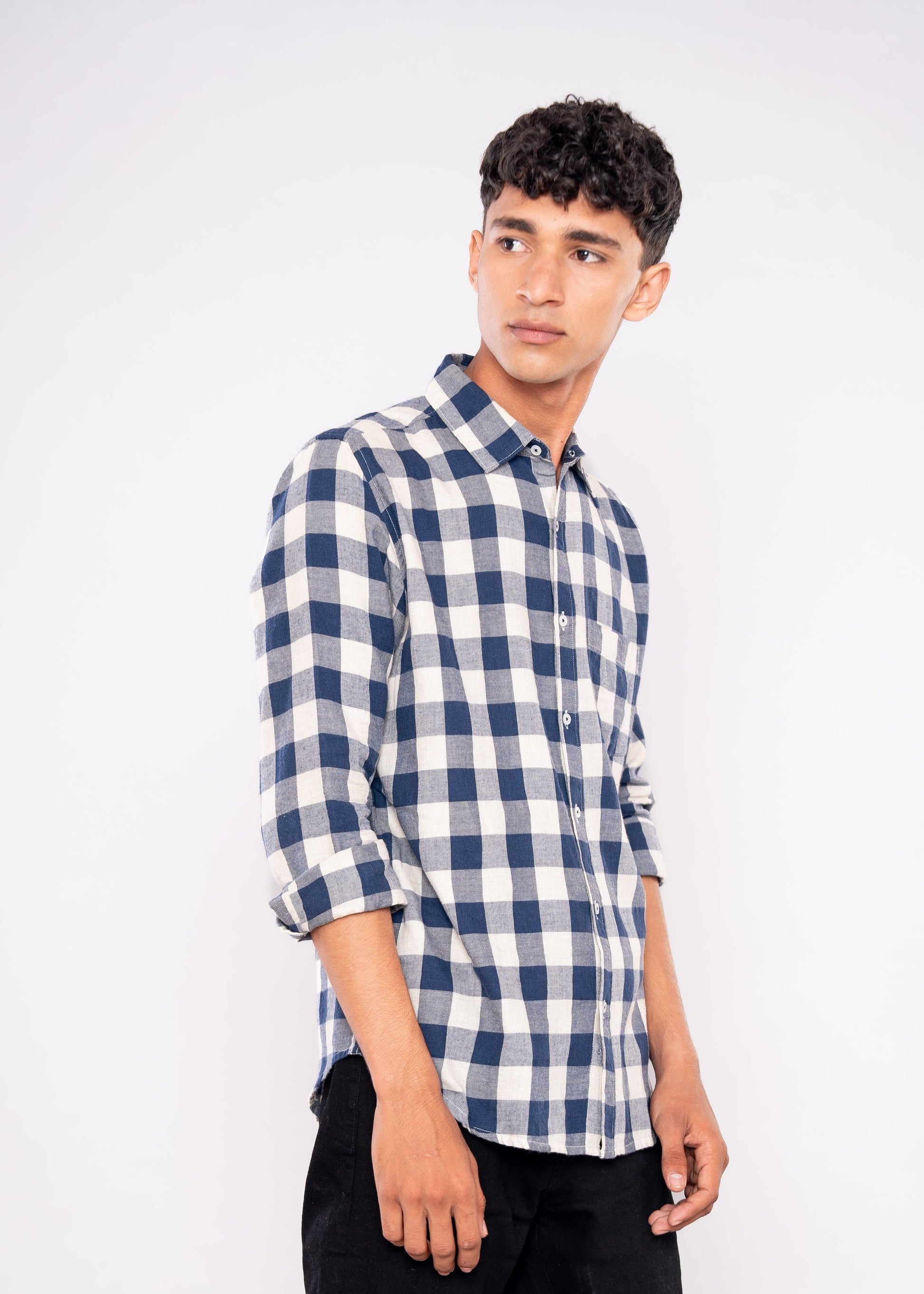Man wearing a blue and white checkered shirt on a white background