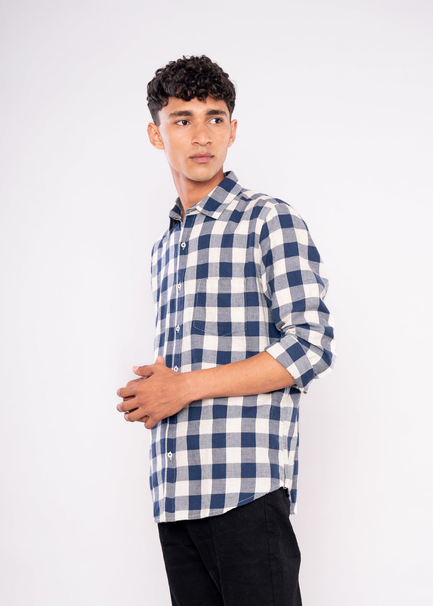 Man wearing a blue and white checkered shirt on a white background