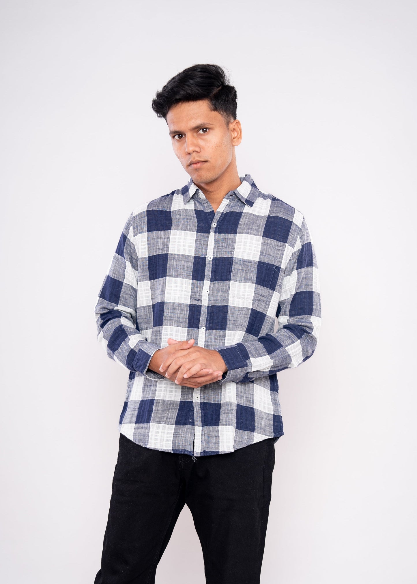 Person wearing a blue and white checkered shirt on a white background