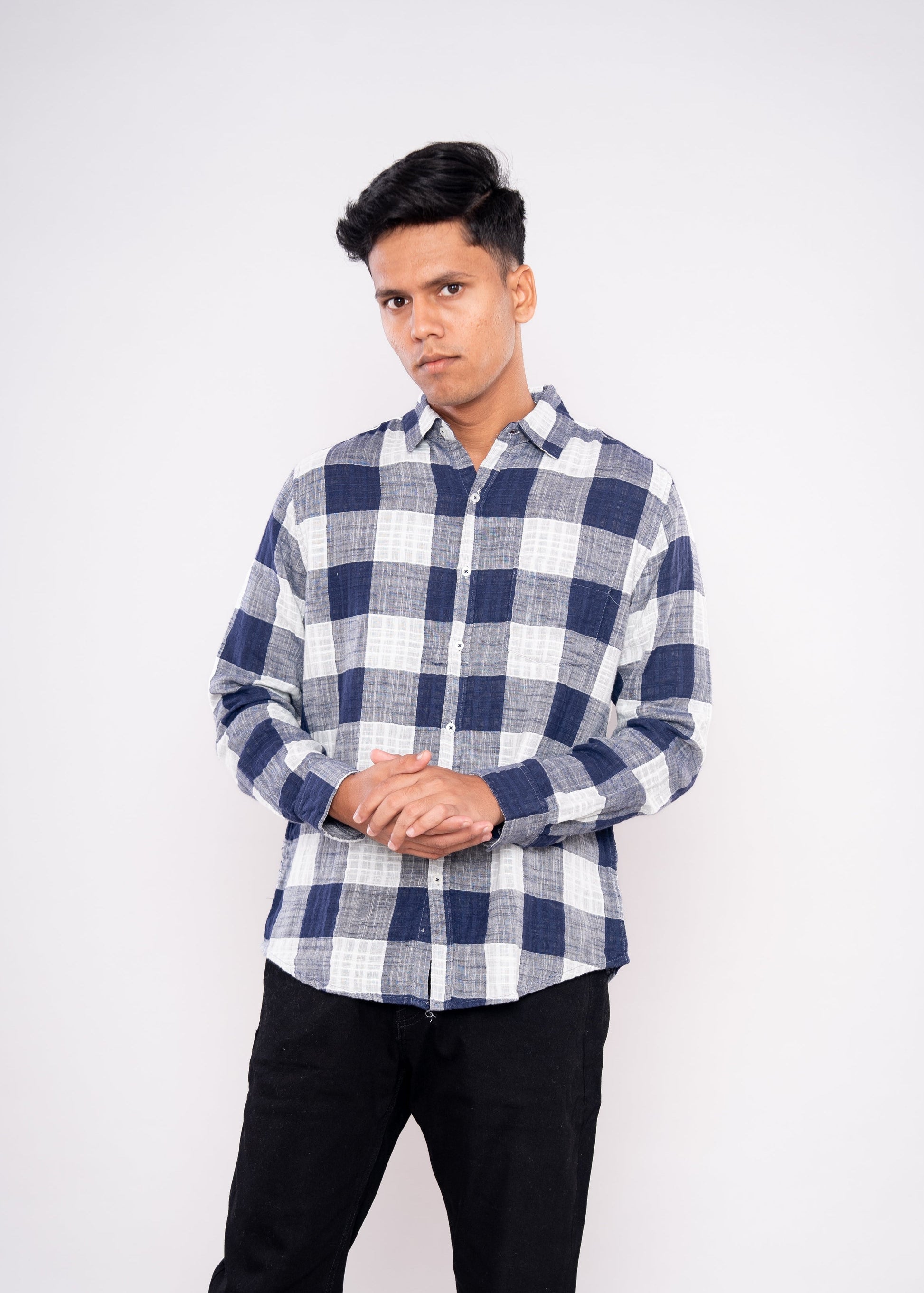 Person wearing a blue and white checkered shirt on a white background