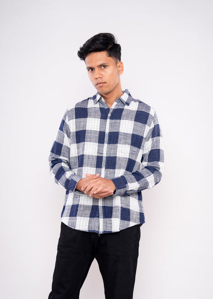 Person wearing a blue and white checkered shirt on a white background